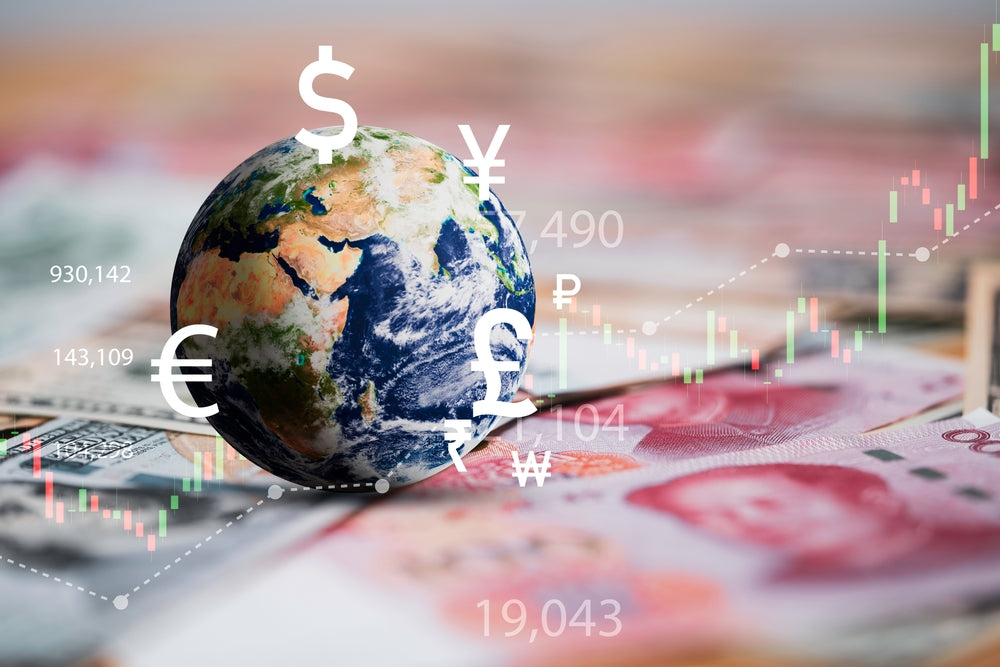 Globe with international currency symbols, charts, and banknotes in the background, representing global financial markets.